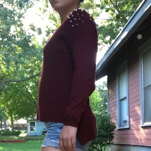 Red sweater with stud detailing